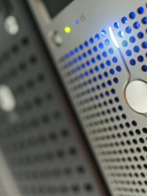 Focused detail of a modern server rack with blue LED indicators in a data center.